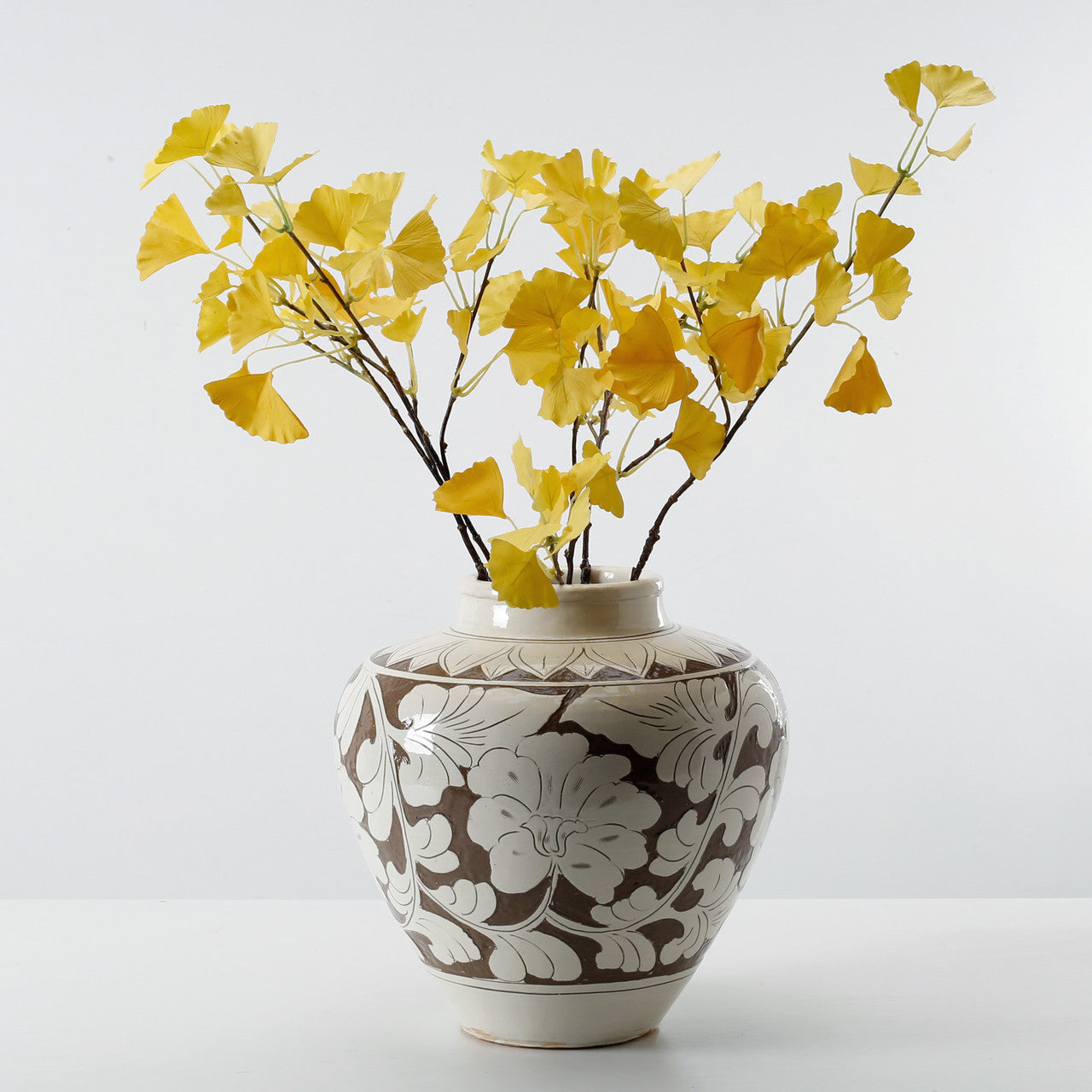 Amalfi Vase with glazed creme surface and terracotta flower pattern, tapered design by DA Atelier.